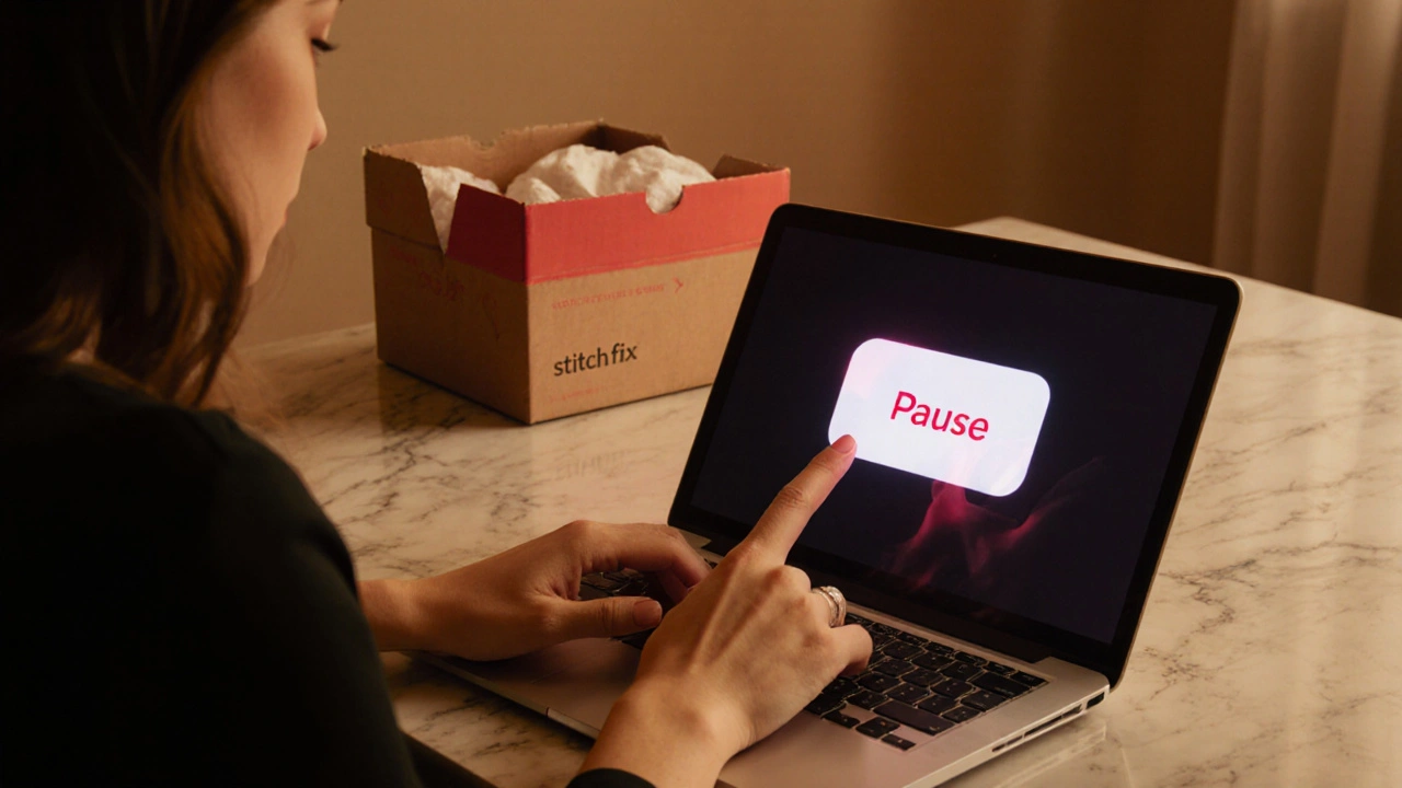 Person pausing a subscription on laptop, with a fashion box in background.